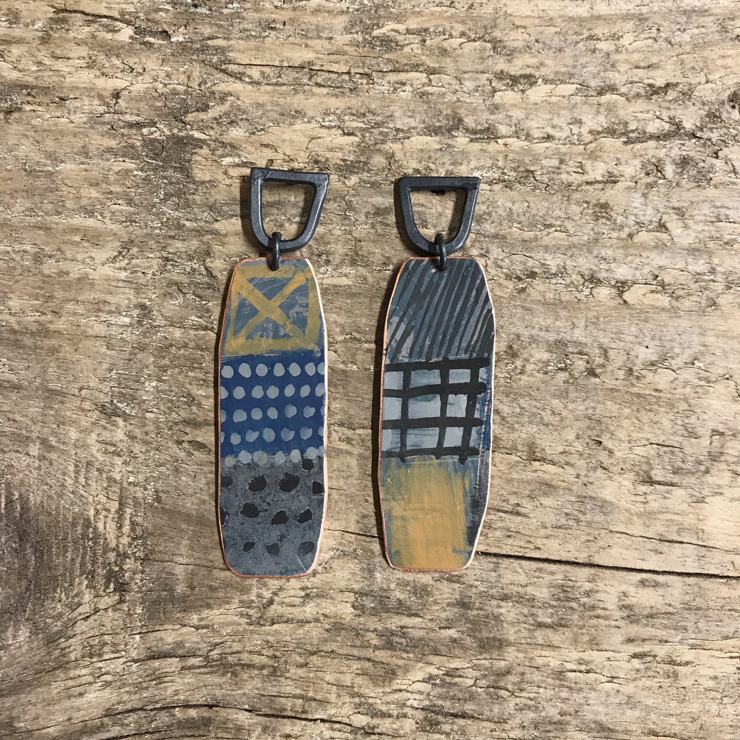 Dark playful painterly earrings with yellow X