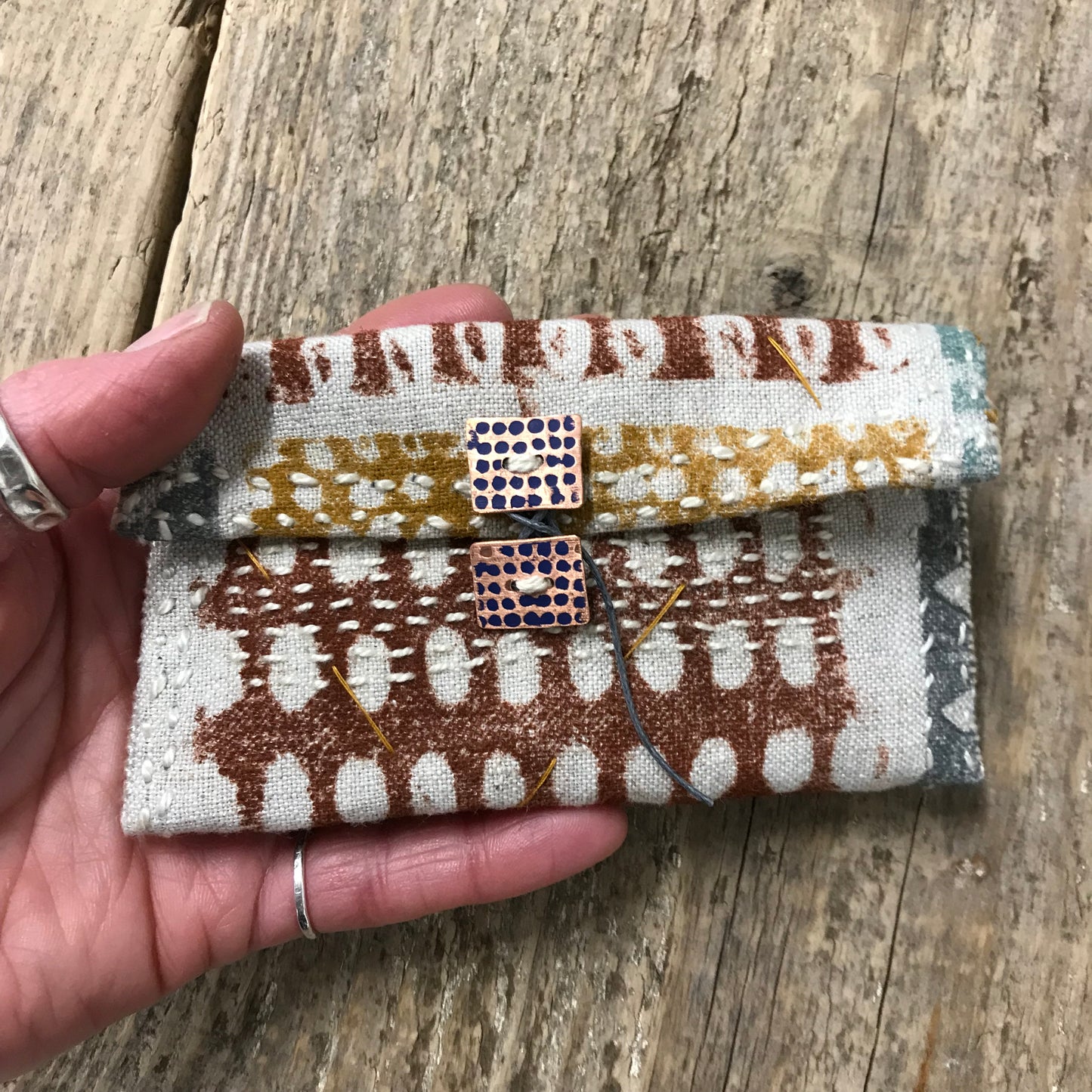 hand stitched keepsake pouch with copper buttons