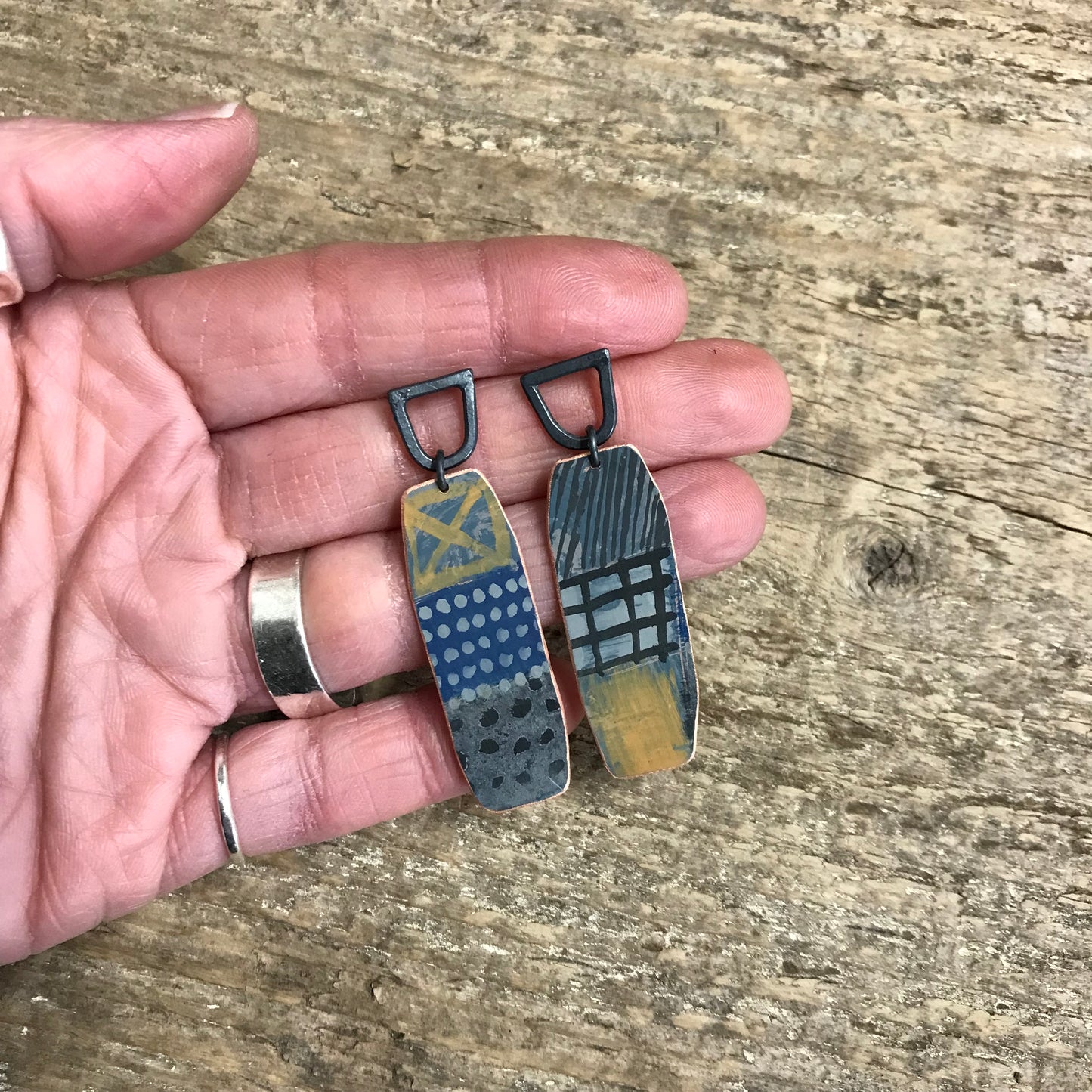 Dark playful painterly earrings with yellow X