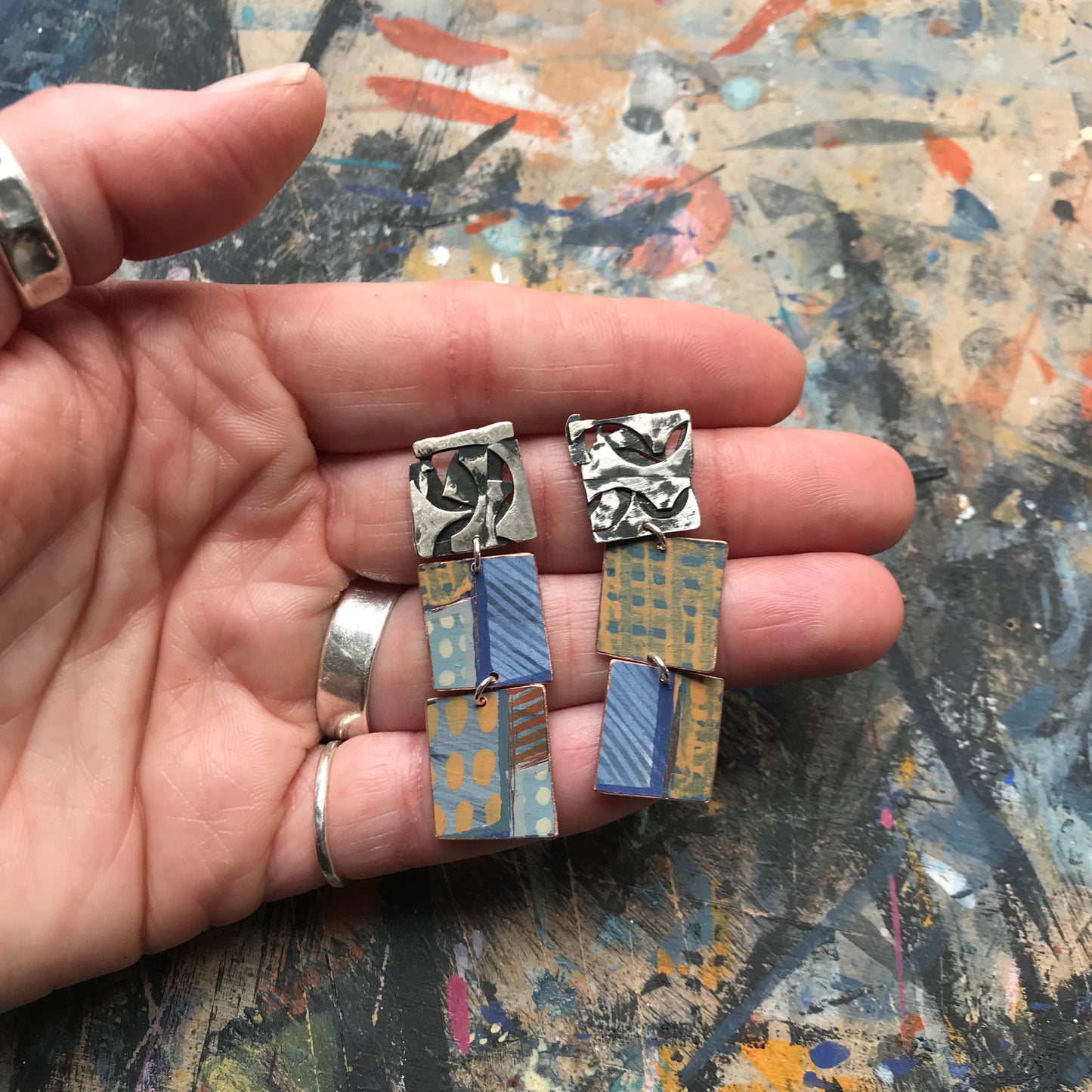 the raw collaged ON THE CUSP earrings with blue stripes