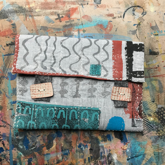 the PALE GREY pouch with textured buttons
